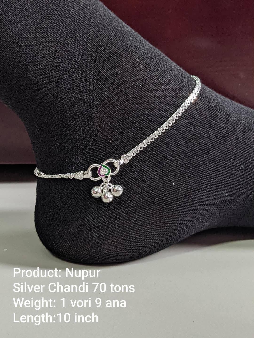 Silver anklet on a dark form, every link clearly visible