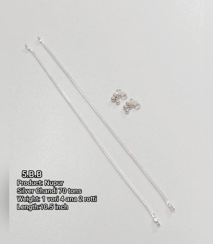 The same style of anklet laid flat on light grey, where the silver disappears